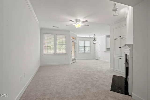 a living room with furniture a chandelier and a dining table with wooden floor