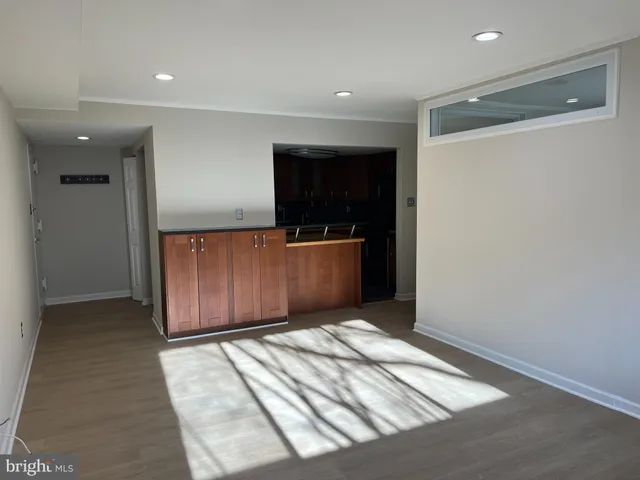 a view of a small space with wooden floor and a window