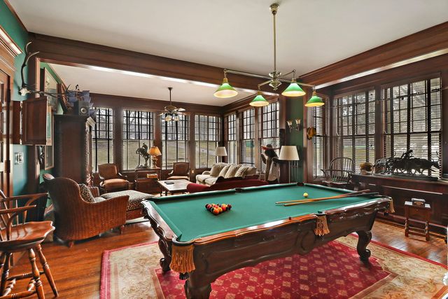 a room with furniture pool table and windows