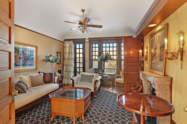 a living room with furniture and a chandelier