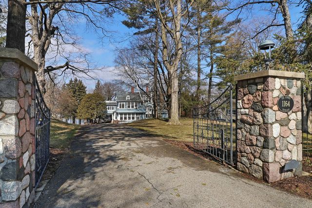 a view of a yard with plants and trees