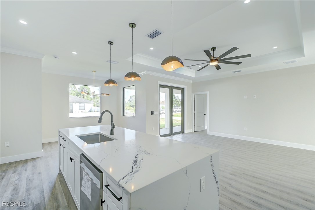 3108 20th Street Southwest Lehigh Acres, FL 33976 - Photo 18 of 36 a kitchen with a sink a counter space and a view of kitchen