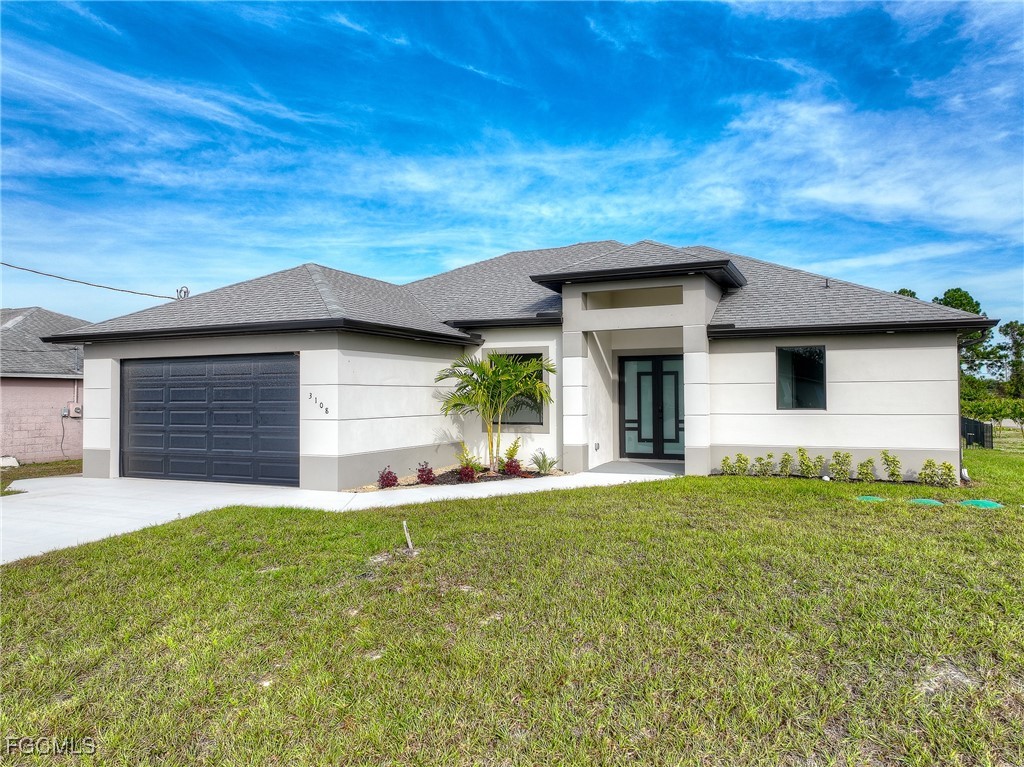 3108 20th Street Southwest Lehigh Acres, FL 33976 - Photo 2 of 36 a front view of a house with a yard and garage