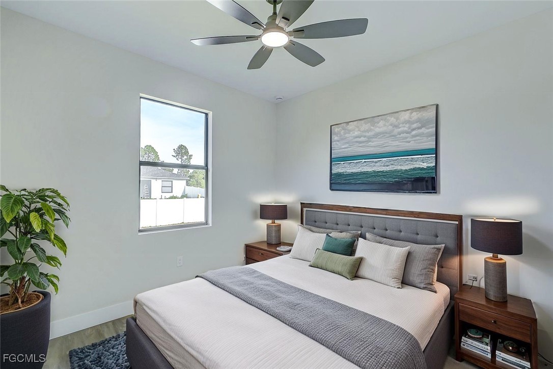 3108 20th Street Southwest Lehigh Acres, FL 33976 - Photo 21 of 36 a bedroom with a bed and a window