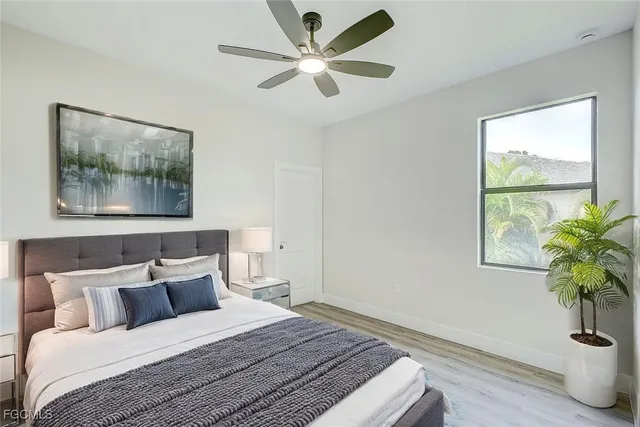 a bedroom with a bed and a potted plant