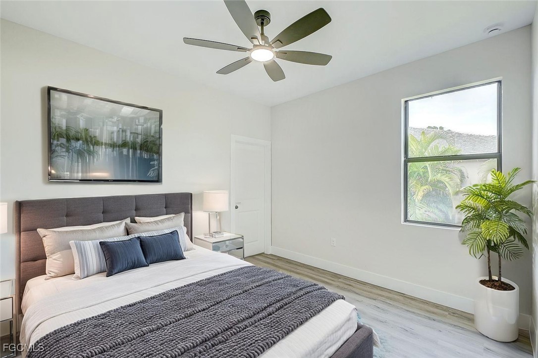 3108 20th Street Southwest Lehigh Acres, FL 33976 - Photo 24 of 36 a bedroom with a bed and a potted plant