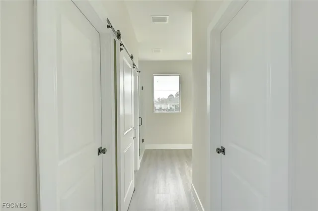 a view of a hallway with wooden floor