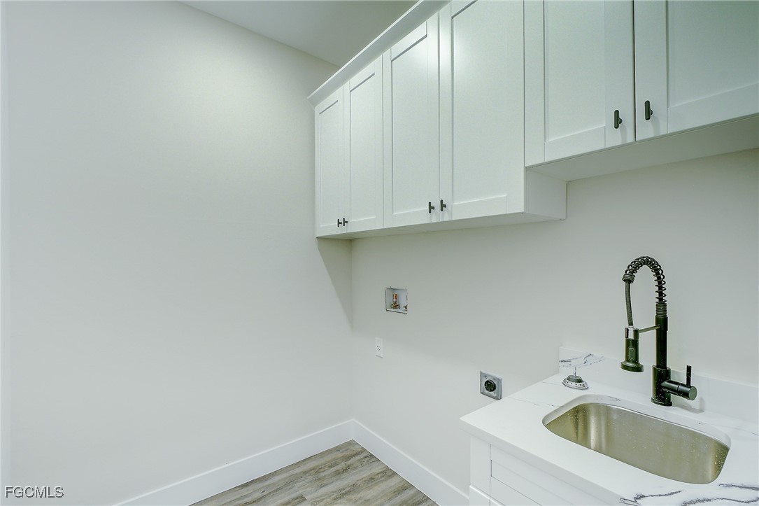 3108 20th Street Southwest Lehigh Acres, FL 33976 - Photo 30 of 36 a bathroom with a sink and cabinets