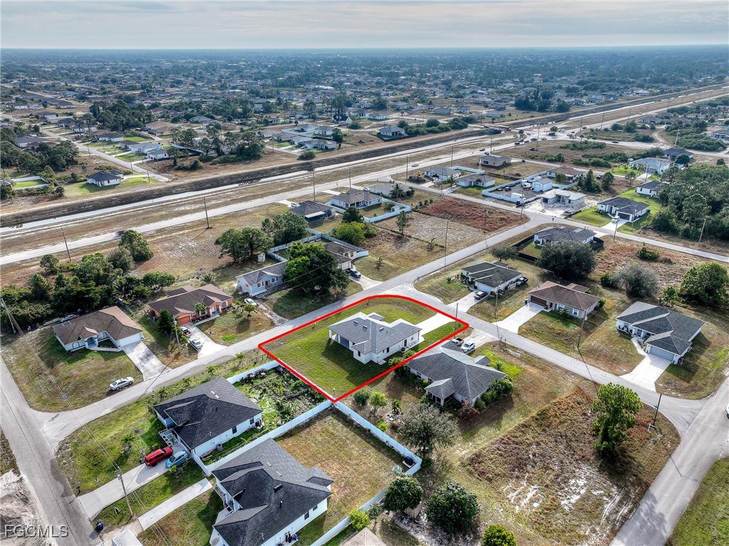 3108 20th Street Southwest Lehigh Acres, FL 33976 - Photo 35 of 36 an aerial view of residential houses with outdoor space