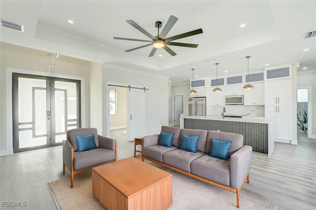 3108 20th Street Southwest Lehigh Acres, FL 33976 - Photo 7 of 36 a living room with furniture and a ceiling fan