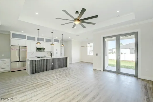 a kitchen with a refrigerator a sink and cabinets