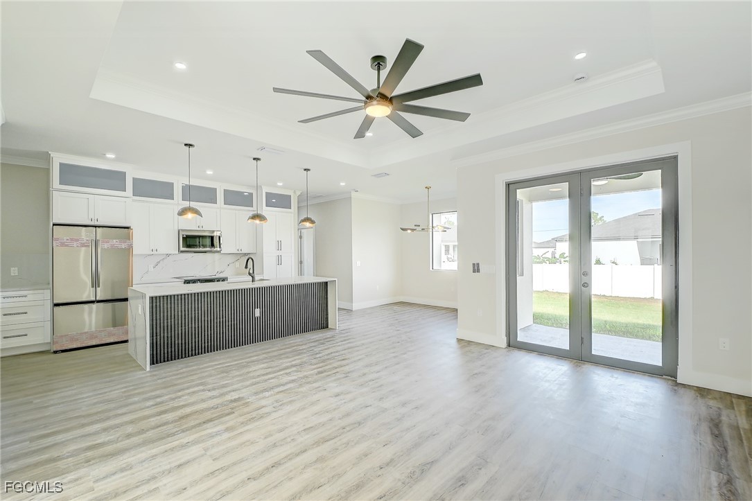 3108 20th Street Southwest Lehigh Acres, FL 33976 - Photo 8 of 36 a kitchen with a refrigerator a sink and cabinets