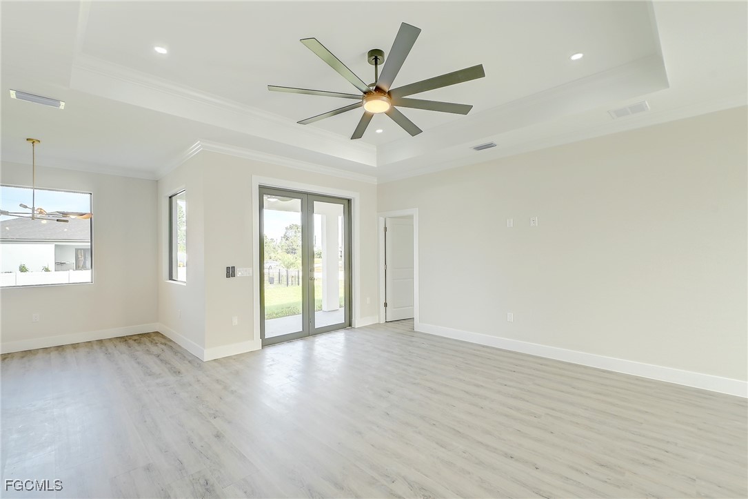 3108 20th Street Southwest Lehigh Acres, FL 33976 - Photo 10 of 36 an empty room with wooden floor fan and windows
