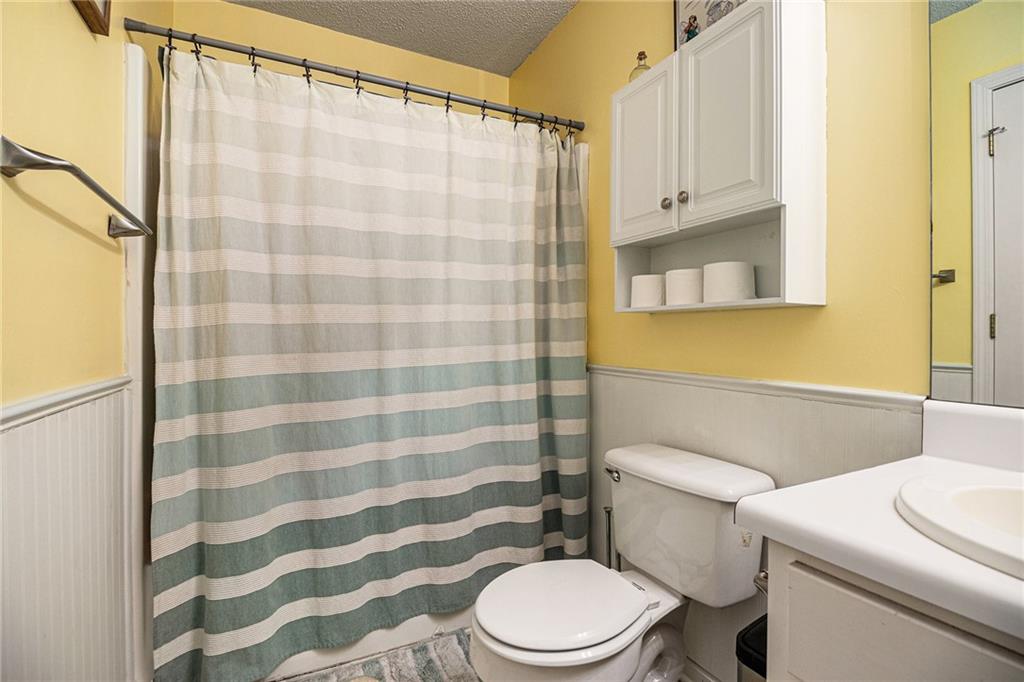 118 Manning Mill Road Adairsville, GA 30103 - Photo 15 of 19 a white toilet sitting next to a shower curtain