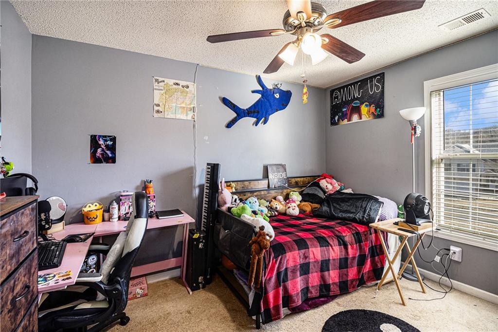 118 Manning Mill Road Adairsville, GA 30103 - Photo 18 of 19 a bedroom with a bed and a chandelier