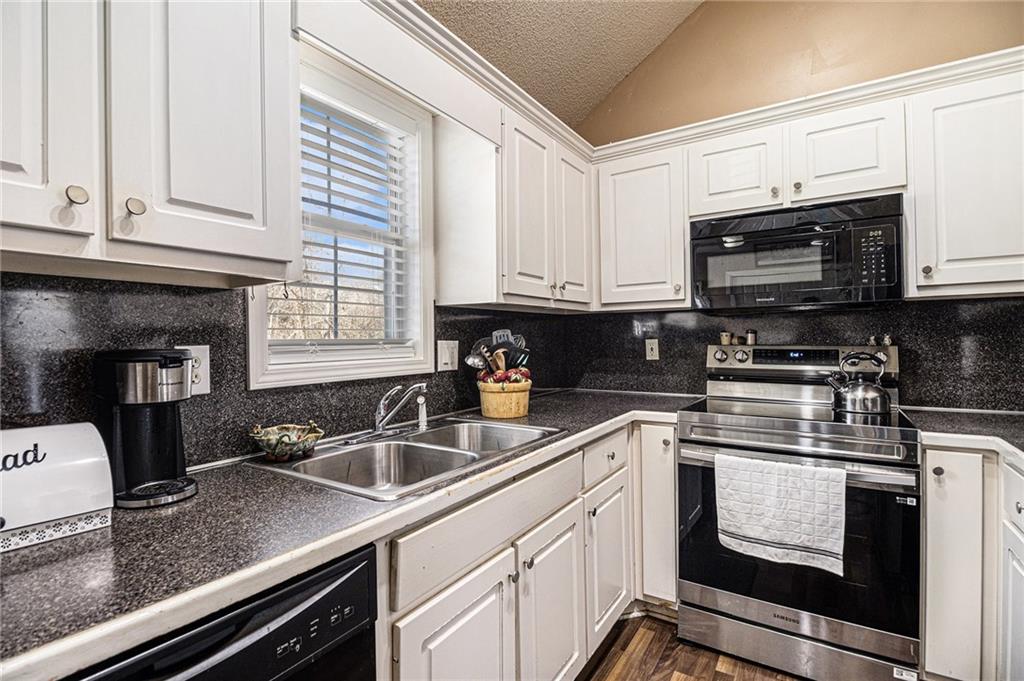 118 Manning Mill Road Adairsville, GA 30103 - Photo 4 of 19 a kitchen with granite countertop a sink cabinets and stainless steel appliances