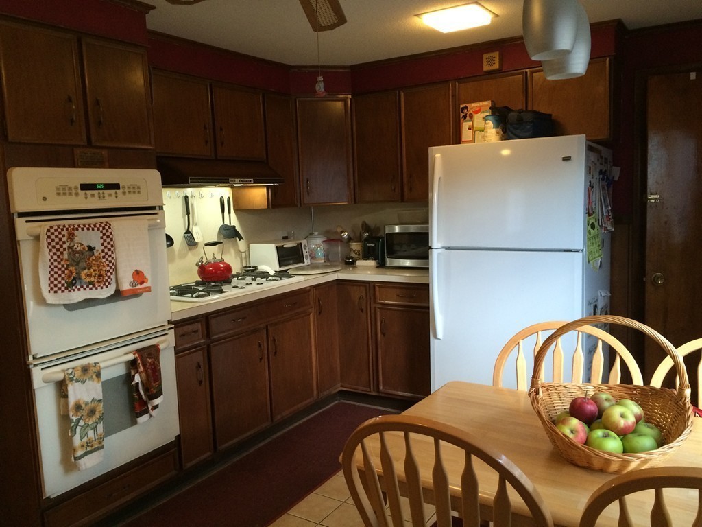 82 Wilber Street Springfield, MA 01104 - Photo 12 of 22 a kitchen with a refrigerator and a stove top oven