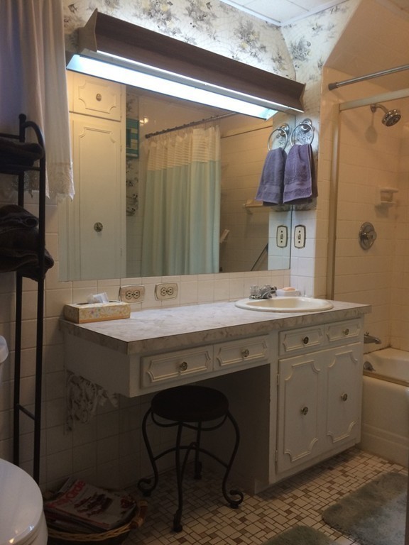 82 Wilber Street Springfield, MA 01104 - Photo 19 of 22 a bathroom with a granite countertop sink a toilet and shower