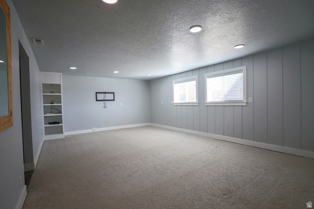 422 West Buckeye Reef Road Leeds, UT 84746 - Photo 25 of 47 Unfurnished room featuring light carpet, a textured ceiling, and recessed lighting