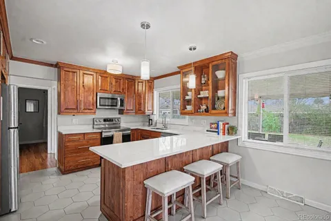 a large kitchen with a table and chairs in it