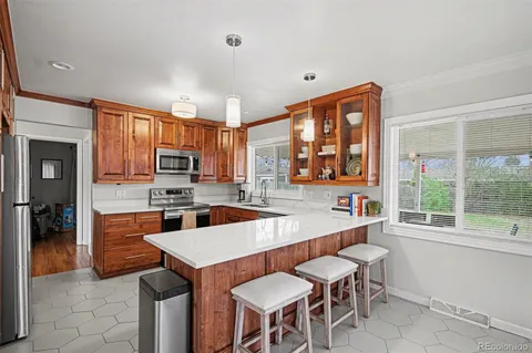 a large kitchen with a table and chairs in it