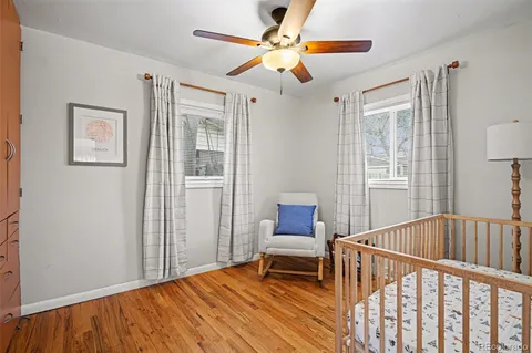 a bedroom with furniture and wooden floor