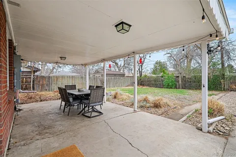 a view of a patio with table and chairs