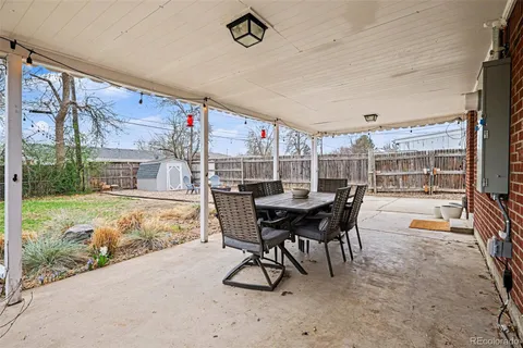 a dining room with furniture and a floor to ceiling window