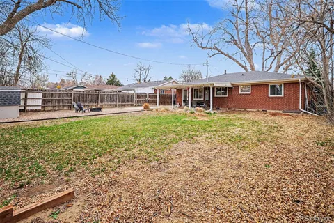 a view of a house with a yard and sitting area