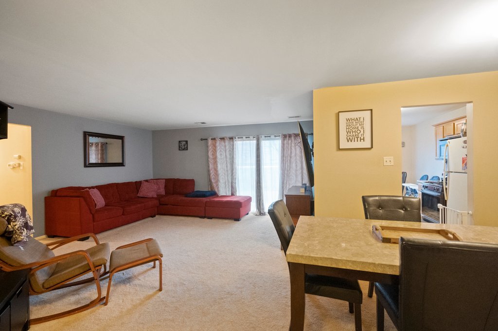 918 East Kings Row, Unit 1 Palatine, IL 60074 - Photo 12 of 36 a living room with furniture and a table