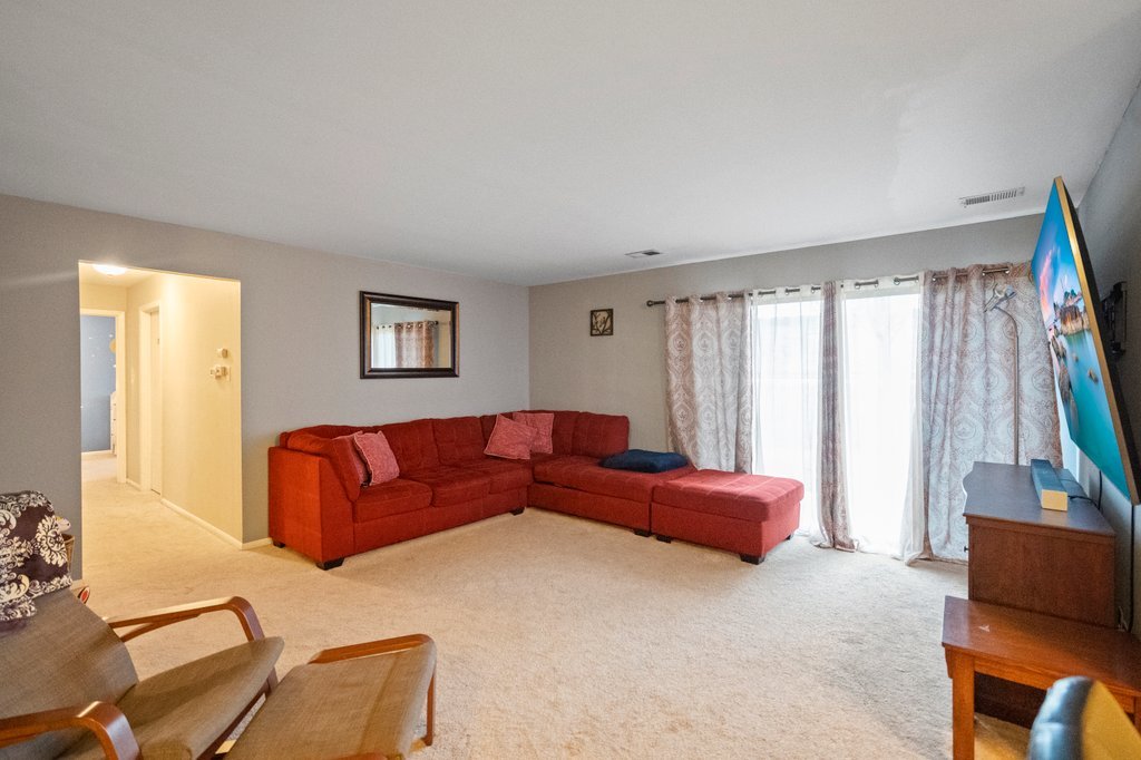 918 East Kings Row, Unit 1 Palatine, IL 60074 - Photo 15 of 36 a living room with a couch and a flat screen tv