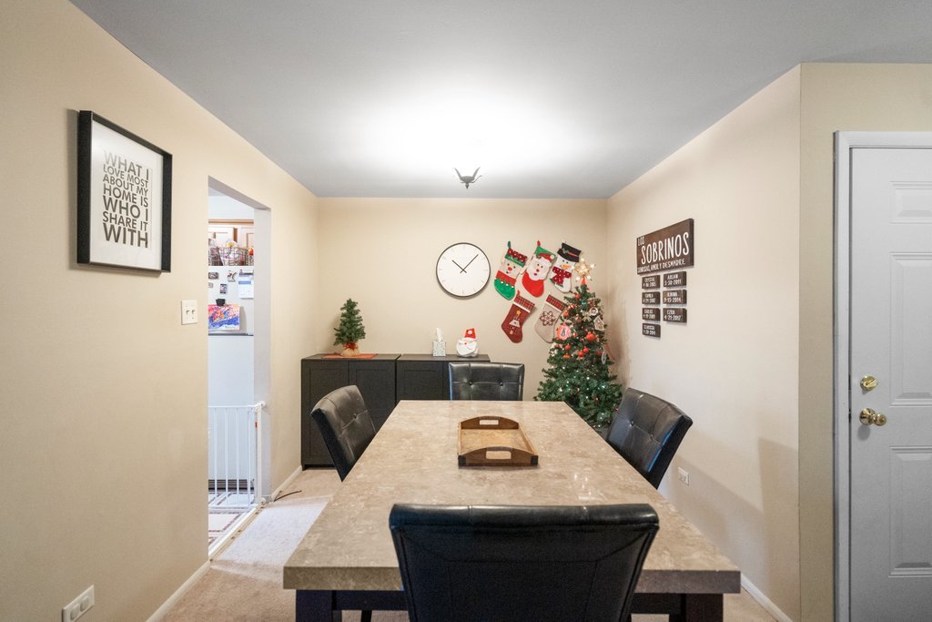 918 East Kings Row, Unit 1 Palatine, IL 60074 - Photo 16 of 36 a view of a dining room with furniture and a table