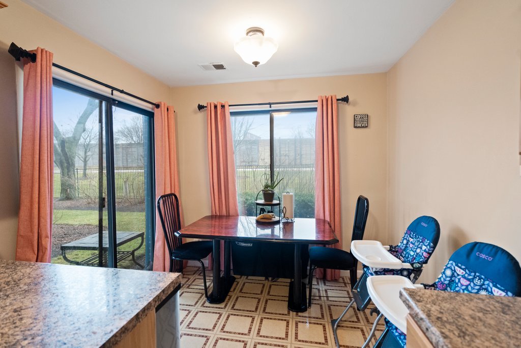 918 East Kings Row, Unit 1 Palatine, IL 60074 - Photo 19 of 36 a view of a dining room with furniture window and outside view