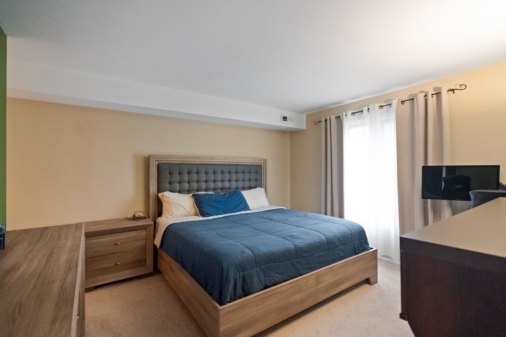 918 East Kings Row, Unit 1 Palatine, IL 60074 - Photo 26 of 36 a bedroom with a bed and a television