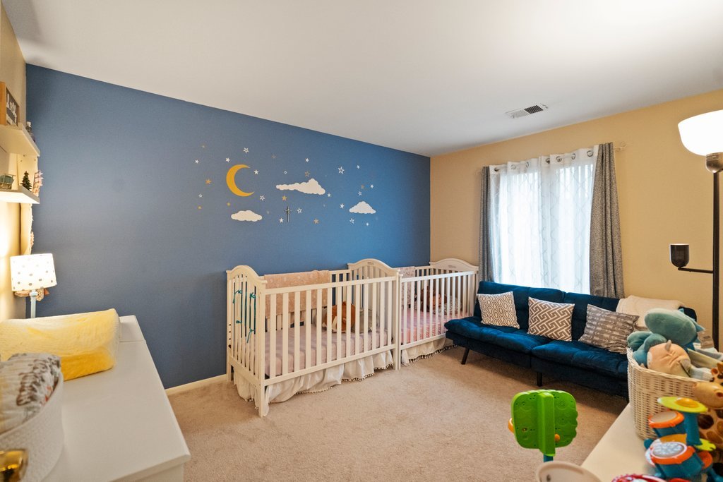 918 East Kings Row, Unit 1 Palatine, IL 60074 - Photo 32 of 36 a bed room with a bed and a couch