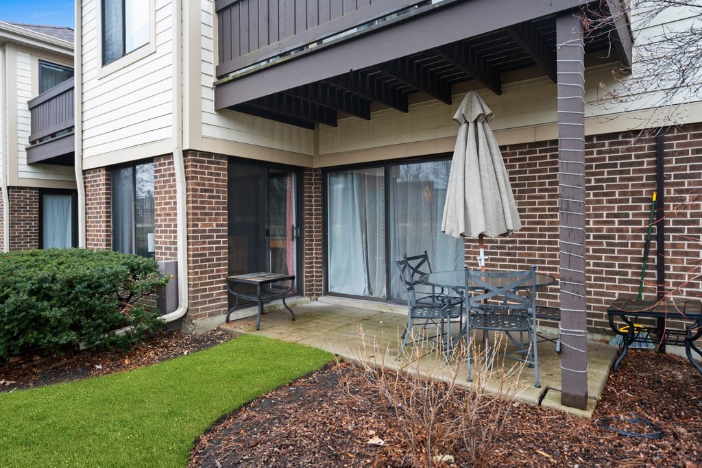 918 East Kings Row, Unit 1 Palatine, IL 60074 - Photo 35 of 36 a view of a chair and table in backyard of the house