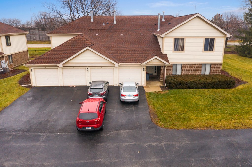 918 East Kings Row, Unit 1 Palatine, IL 60074 - Photo 4 of 36 a front view of a house with cars parked