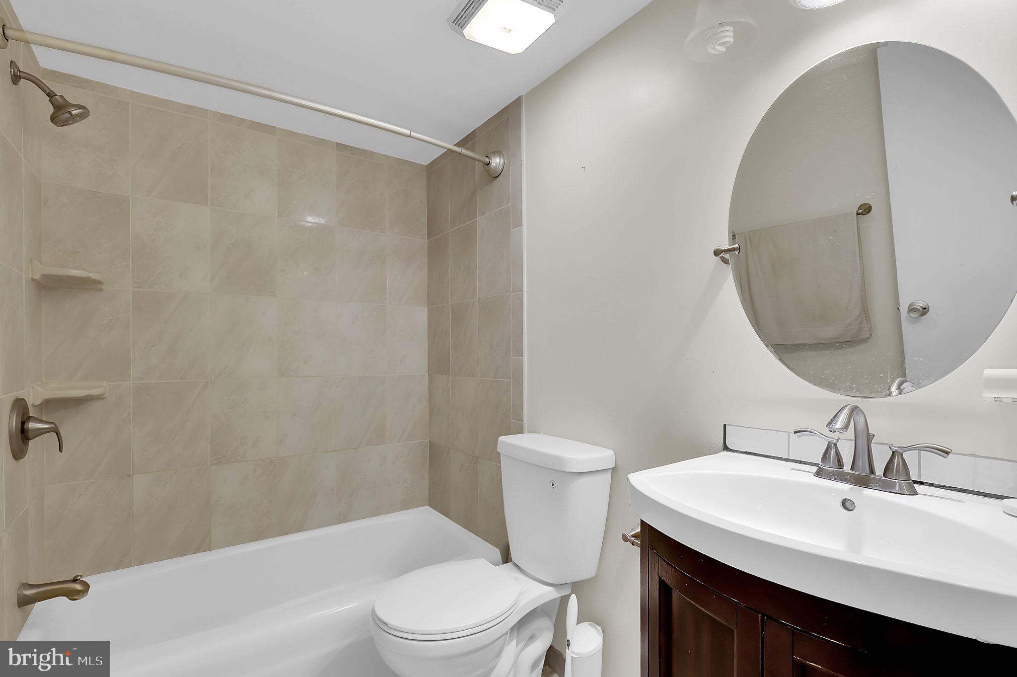 19309 Club House Road, Unit 19309 Gaithersburg, MD 20886 - Photo 15 of 24 a bathroom with a sink toilet and shower