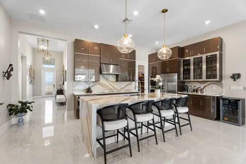a large kitchen with a table and chairs