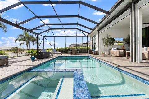 an aerial view of a house with a swimming pool yard and mountain view in back