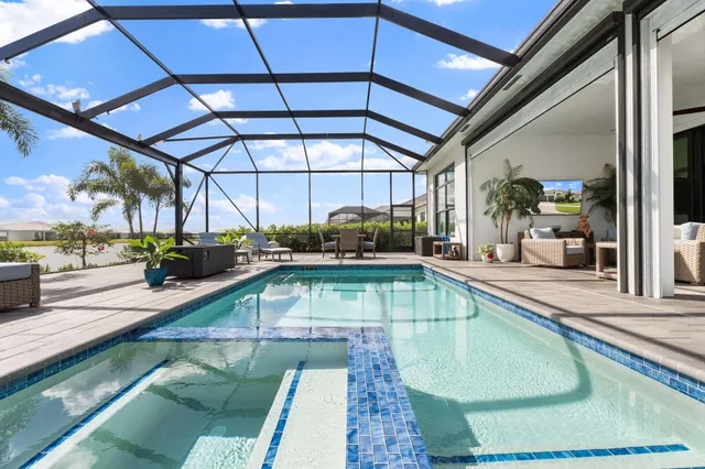 an aerial view of a house with a swimming pool yard and mountain view in back