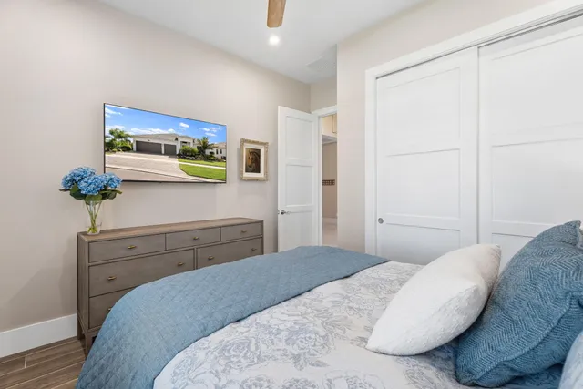 a bathroom with a sink a toilet a mirror and shower