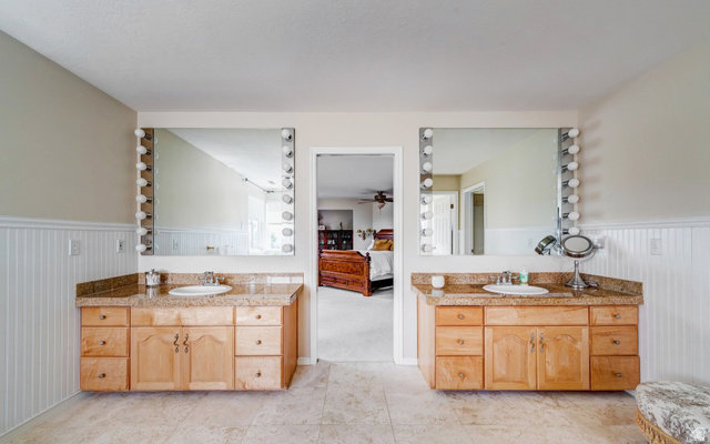 1273 Grayson Court Sandy, UT 84094 - Photo 19 of 27 Dual vanity with light wood cabinetry, stone countertops, and integrated sinks