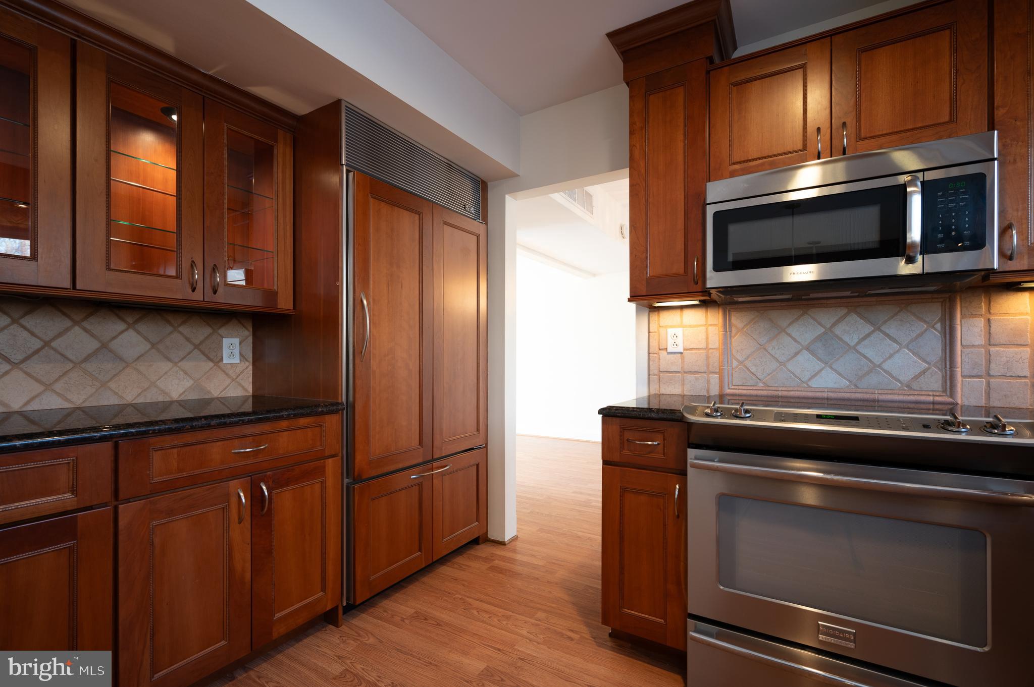 128 Birch Knoll Road Wilmington, DE 19810 - Photo 16 of 51 a kitchen with granite countertop wooden cabinets stainless steel appliances and a window