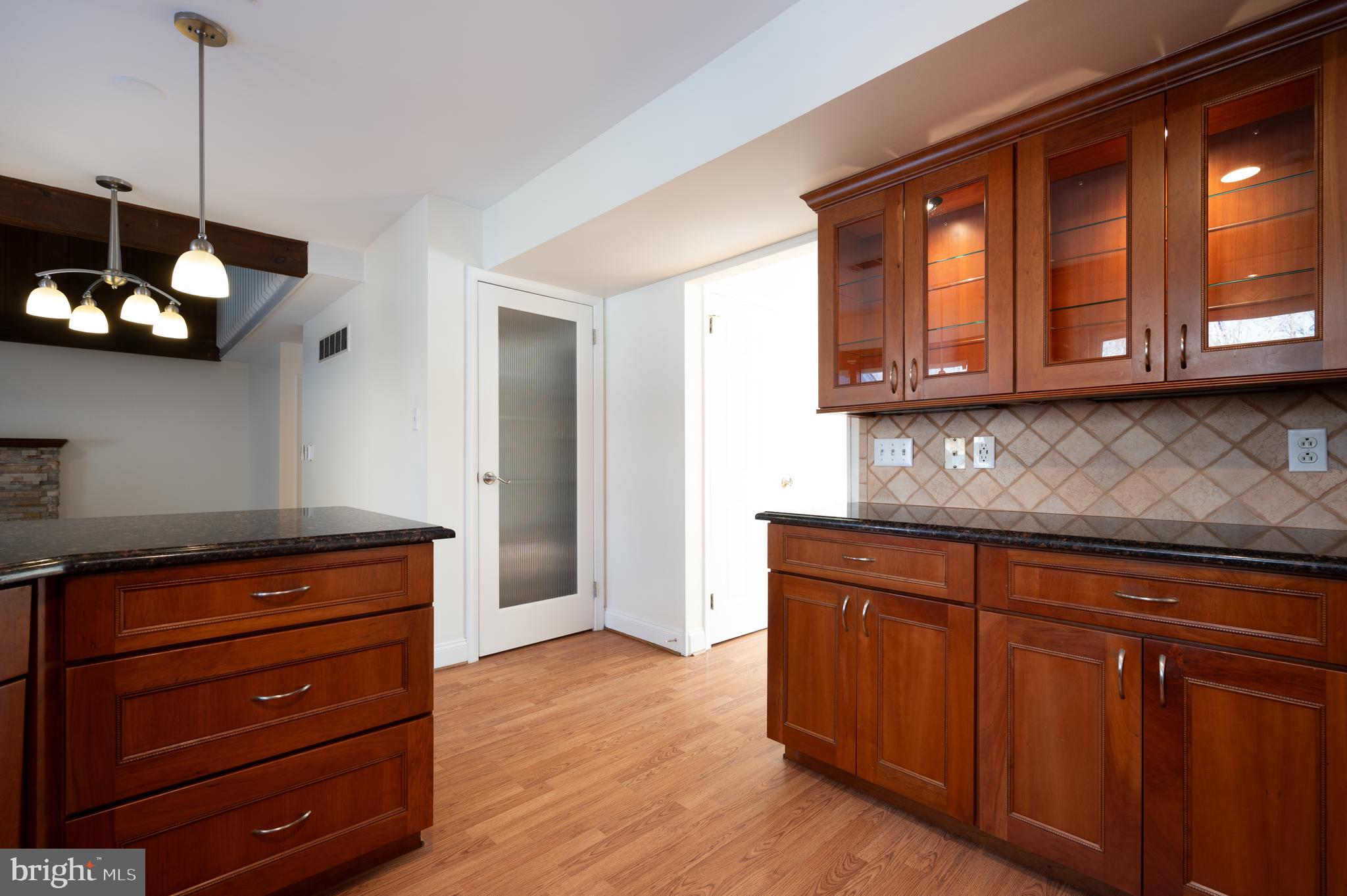 128 Birch Knoll Road Wilmington, DE 19810 - Photo 18 of 51 a kitchen with wooden cabinets and a wooden floor