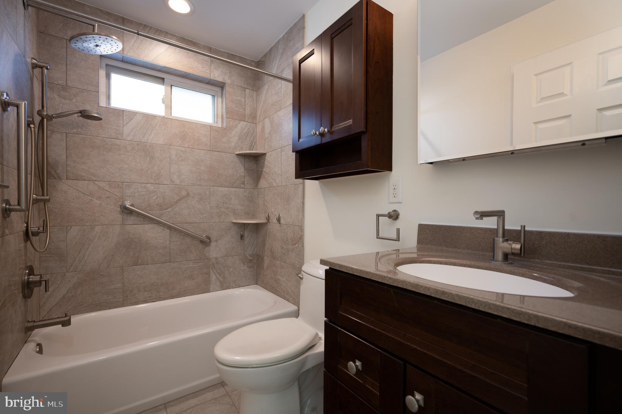 128 Birch Knoll Road Wilmington, DE 19810 - Photo 36 of 51 a bathroom with a sink a toilet a mirror and bathtub