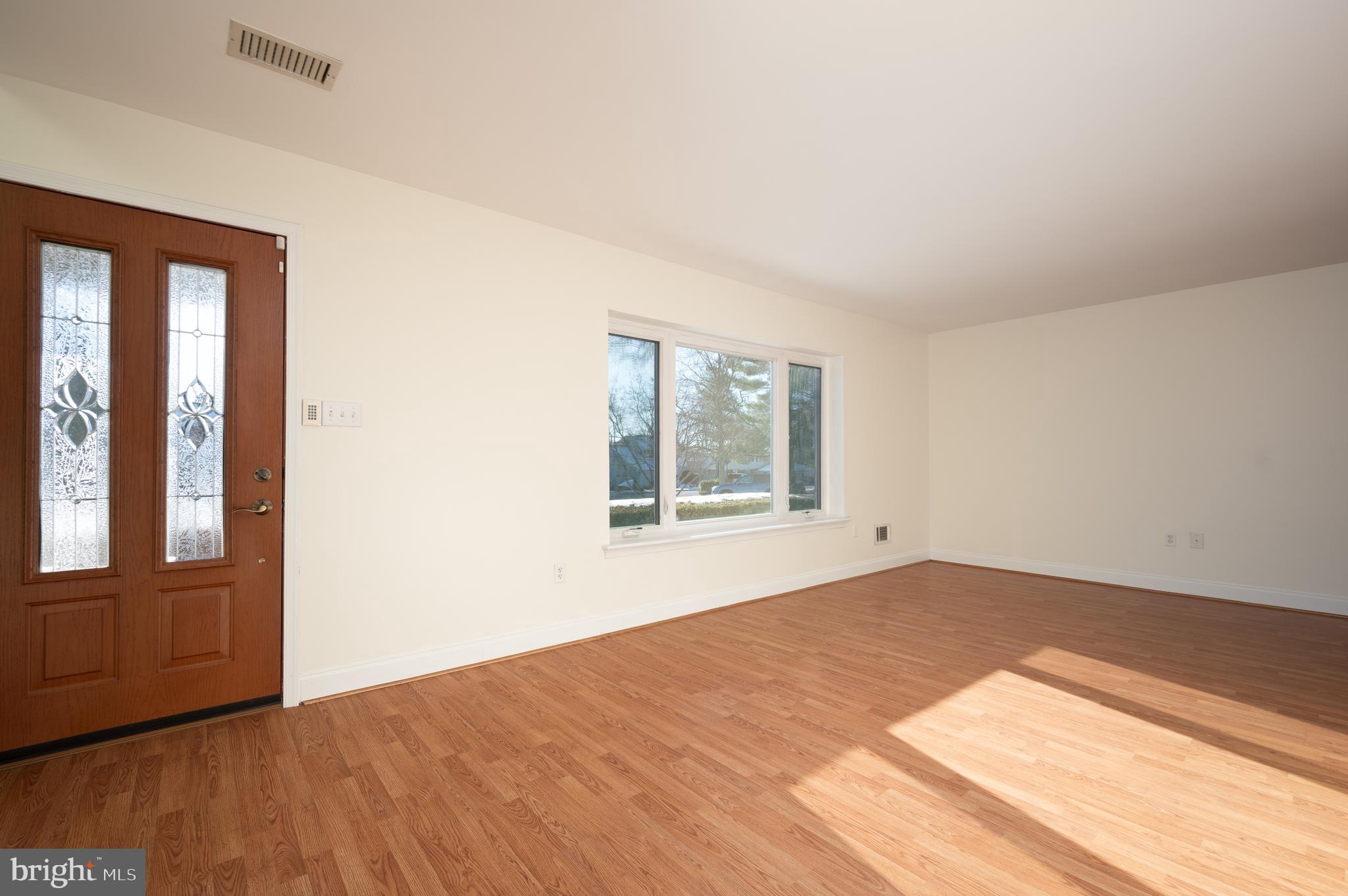 128 Birch Knoll Road Wilmington, DE 19810 - Photo 9 of 51 a view of an empty room with wooden floor and a window