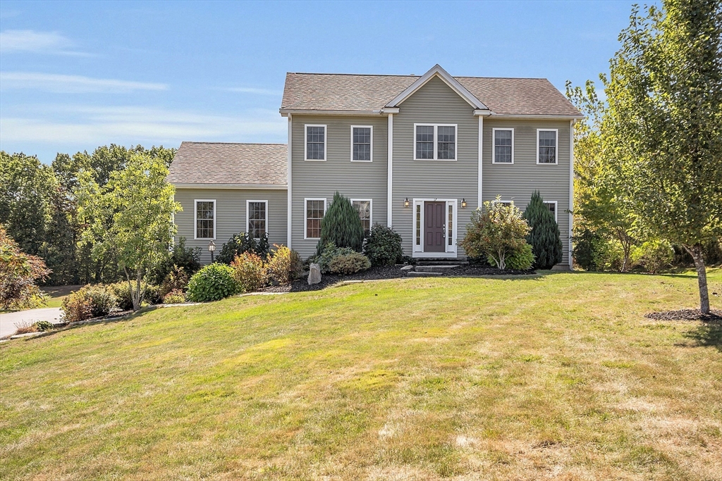 17 Runaway Brook Road Lancaster, MA 01523 - Photo 1 of 42 a front view of house with yard and trees in the background