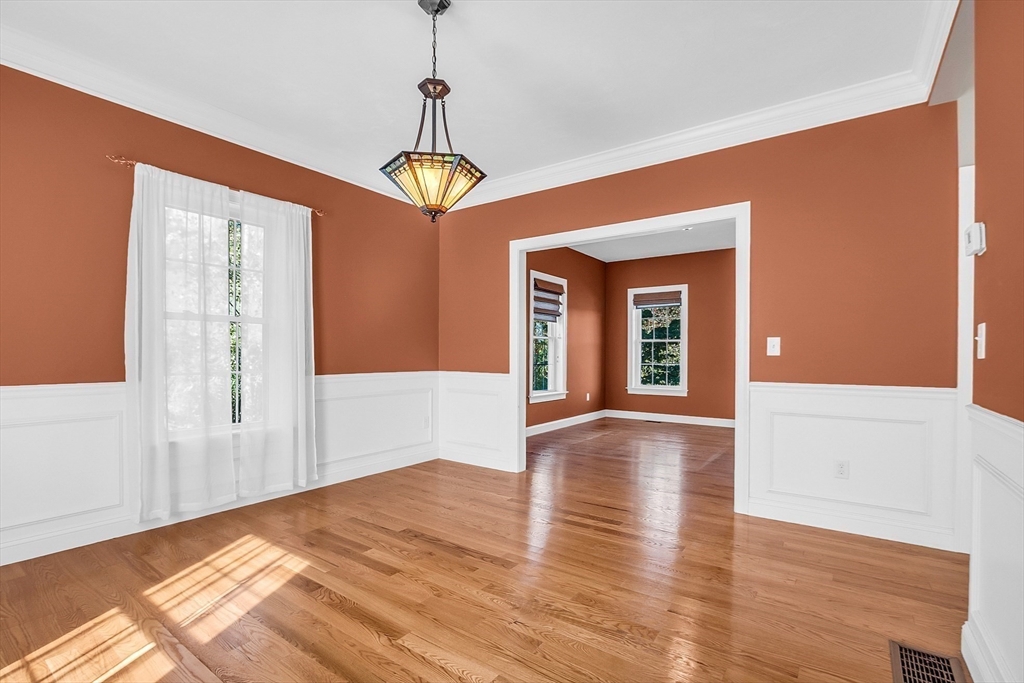 17 Runaway Brook Road Lancaster, MA 01523 - Photo 11 of 42 a view of an empty room with wooden floor and a window