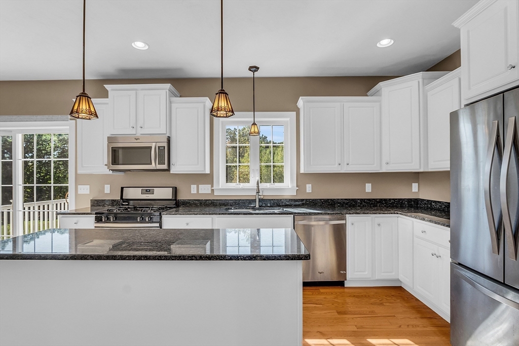 17 Runaway Brook Road Lancaster, MA 01523 - Photo 17 of 42 a kitchen with stainless steel appliances granite countertop a sink a stove and a refrigerator